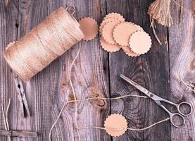 coil of brown rope, paper tags and old scissors photo