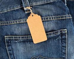 tied brown blank tag on blue jeans photo