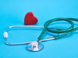 green medical stethoscope and  red decorative heart photo