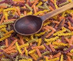 multicolored spiral raw pasta fusilli photo