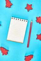 notebook with empty white sheets in line and red wooden pencil photo