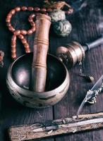 copper singing bowl and a wooden stick photo