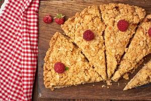 sliced triangular pieces of crumble pie with apples photo