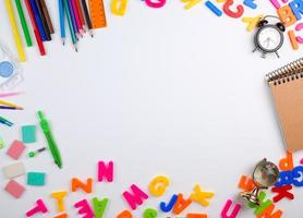 set of different school colorful items for learning at school on a white background, the middle space photo