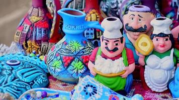 Telavi, Georgia , 2022 - beautiful souvenirs wine mugs and porcelain figures in Kakheti local seller stalls video