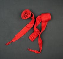 pair of textile red bandages for winding hands to athletes before sports training photo
