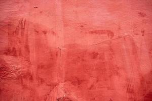 fragment of a red cracked cement wall photo