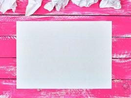 blank white rectangular sheet of paper and crumpled pieces of paper photo