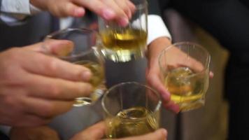 Businessmen drink alcoholic beverages from beautiful glasses. video