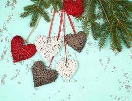 green branches of spruce and wicker hearts on a rope photo
