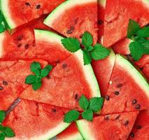 sliced triangular slices of ripe red watermelon with seeds photo