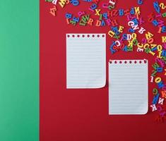 two empty sheets in a line on a red background photo