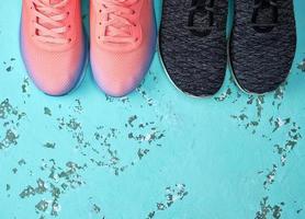 two pairs of sports sneakers on a green background photo