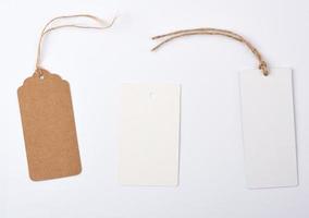 empty paper round and rectangular brown tag on a rope photo