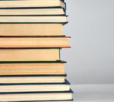 stack of different books on a gray background photo
