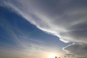 Clouds and light effects in the sky at dawn or dusk. photo