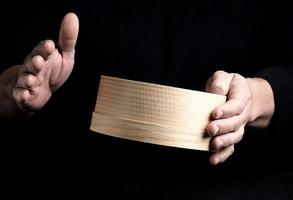 two male chef hands hold a round wooden sieve photo