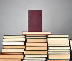 a stack of different books on a gray background photo