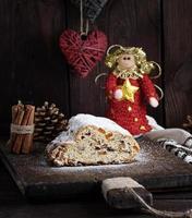 Christmas stollen cake with icing sugar, marzipan and raisins photo