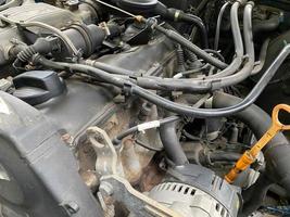 Powerful tuned gasoline engine with a turbocharger and a charger in the engine compartment of an automobile with an open hood and a turbine in a car repair and improvement workshop photo