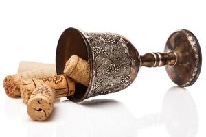 Old goblet and wine corks photo