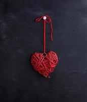 small wicker red heart hangs on a rope photo