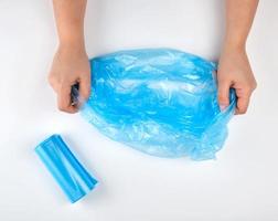 blue plastic garbage bag in hands photo