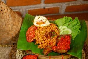 spicy noodle food with additional omelet and fried chicken photo