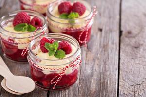 Colorful and delisious dessert in a jar berry cramble photo