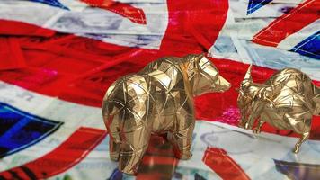 The gold bull bear on uk flag for business concept 3d rendering photo
