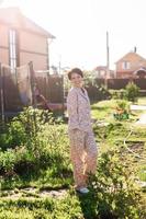 Cheerful woman in home wear pajama summer outdoor backyard in home - sleepwear and homewear concept photo