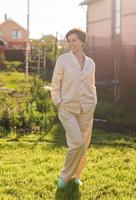 Cheerful woman in home wear pajama summer outdoor backyard in home - sleepwear and homewear concept photo
