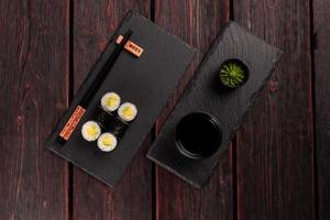 Maki sushi roll with avocado with chopsticks top view. Sushi menu. Japanese food. photo