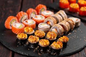 Rolls set with fish shrimp and caviar sushi with chopsticks - asian food and japanese cuisine concept photo