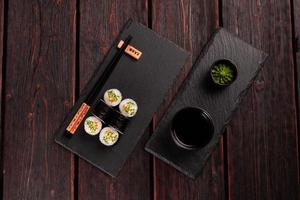 Maki sushi roll with cucumber and sesame with chopsticks top view. Sushi menu. Japanese food. photo