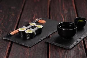 Maki sushi roll with cucumber and sesame with chopsticks. Sushi menu. Japanese food. photo