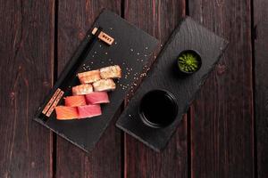 Rolls set with fish salmon and shrimp and tuna maguro eel sushi with chopsticks top view - asian food and japanese cuisine concept photo