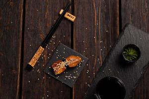 Japanese sushi smoked eel on wooden background top view photo