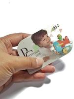 West Java, Indonesia on July 2022. Isolated photo of a hand holding a loyalty card, Mothercare ID Priviledge Card.