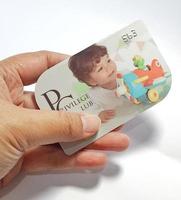 West Java, Indonesia on July 2022. Isolated photo of a hand holding a loyalty card, Mothercare ID Priviledge Card.