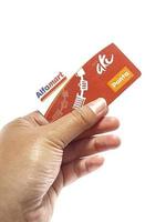 West Java, Indonesia on July 2022. Isolated photo of a hand holding a loyalty card, Alfa Gift Card.
