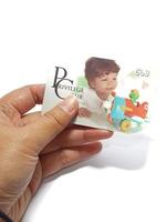 West Java, Indonesia on July 2022. Isolated photo of a hand holding a loyalty card, Mothercare ID Priviledge Card.