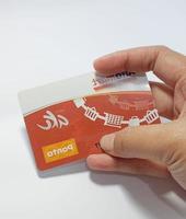 West Java, Indonesia on July 2022. Isolated photo of a hand holding a loyalty card, Alfa Gift Card.