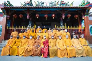 Bandung City, Indonesia, 2022 - The monks sitting together for taking a photo in front of the Chinese gate