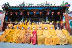 Bandung City, Indonesia, 2022 - The monks sitting together for taking a photo in front of the Chinese gate