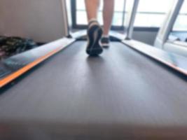 Blur image about exercising on walking treadmill at gym. Concept for healthy and lose weight. photo