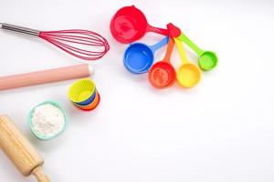 Top view set of kitchen utensils and ingredients for bakery on white background. Materials or kitchen equipment for bakery. photo