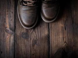 pair of leather brown shoes on a wooden background photo