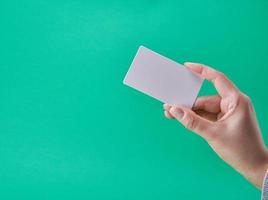 white paper business card in a female hand photo