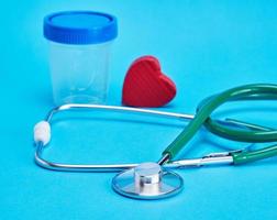 green medical stethoscope and  red decorative heart photo